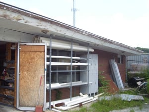This is the right side of the old concession stand....as you can see, unlike the other side the glass in the double doors has been busted out and replaced by plywood, the the glass in the large windows just behind this scaffolding is intact.   The poor st