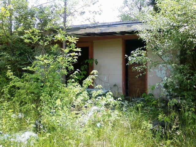 The consession stand is still there, but trees and bushes are over taking it. These are the bathrooms....nothing left inside.