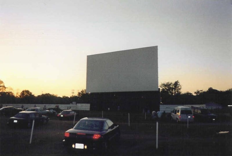 This is screen 1 with the kids playing in the grass in front of the screen.