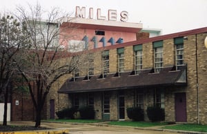 Miles tower in its latter-day context, surrounded by small businesses and light industry.