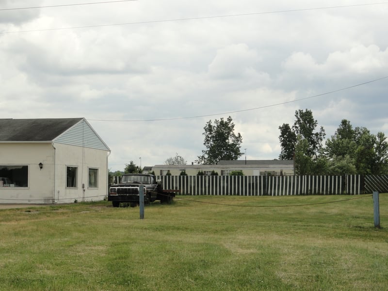 former site concession building and fencing