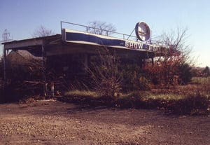 Twin ticket booths hidden behind bushes