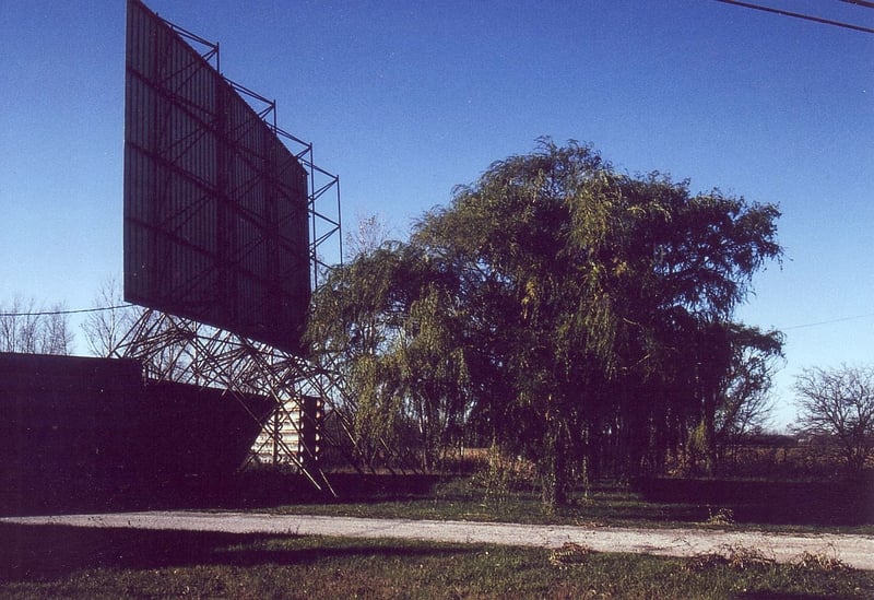 View at the main screen with the exit road in the foreground. The ticket booth is hidden behind the tree