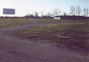 Field with remaining speaker poles, projection/concession building and screen no. 2