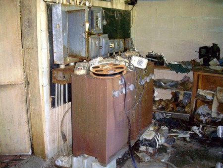 The ballasts & breakers for the projectors. Still in good shape, though rusting some. This theatre IS being watched, so don't get any ideas of stealing or vandalizing items, please. Let's see it running again rather than ruined!