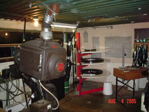 projection booth..."Dark Water" is being fed out of the lower deck of the platter with the top deck being the takeup. The second show, "The Island," is on the middle deck.