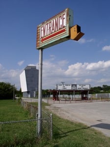 Old Entrance Sign with Ticket Booth, Marquee & Screen Tower in Background.