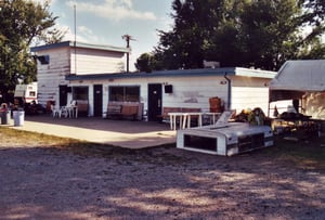 The projection/concession building sits at the back of the field