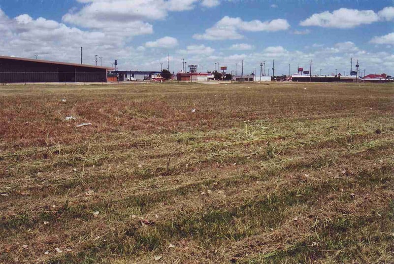 Another shot of the empty field looking towards  Eddie Cordes Dodge large building at right
