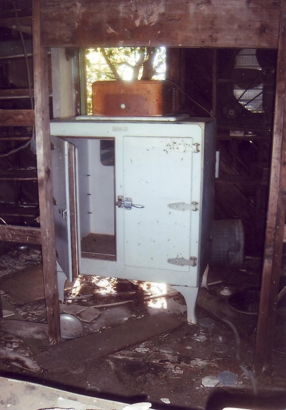 An old fridge with the compressor on top