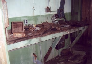 A workbench in the projection room with the shell of a speaker