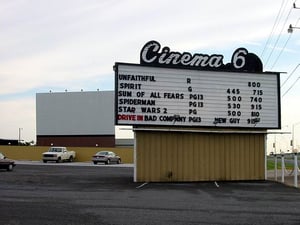 Cinema 69 Marquee with movie listing for the indoor screens and the Drive-In.  The outdoor screen is in the background.