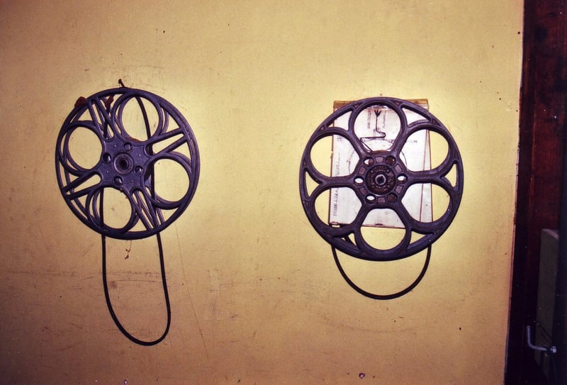 2 film reels from one of the projectors still hanging on the wall