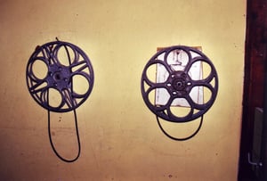 2 film reels from one of the projectors still hanging on the wall