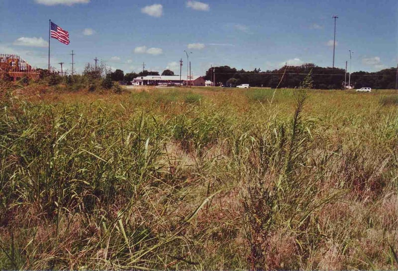 Field next to a new building construction