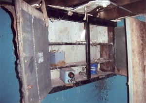 Small wooden cabinet still hanging on the back wall of the projection booth