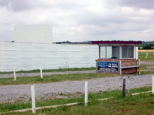 Entrance with ticket booth and screen in the background