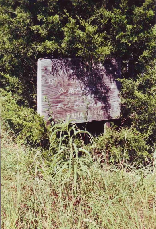 Weathered instruction board for tire guard:"Do not back up!"