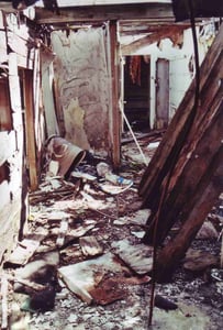 Messed up snack bar with open door leading into a storage room in background