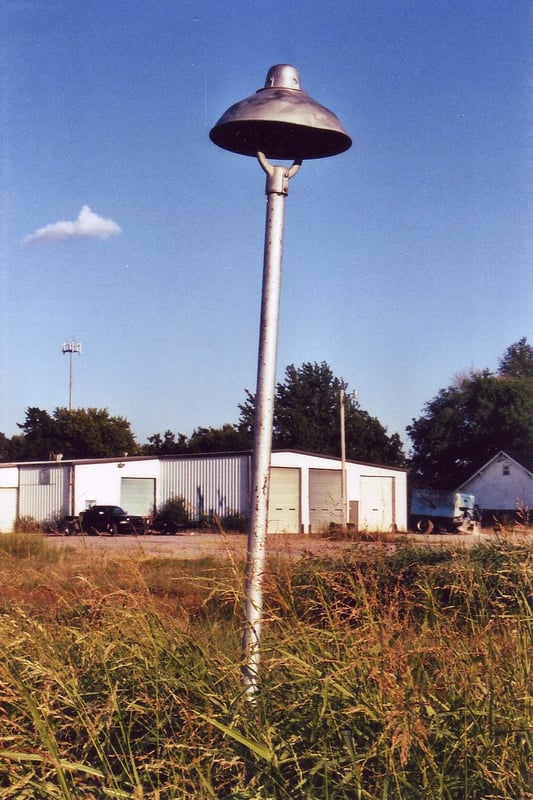 A tall light fixture still stands along the exit road