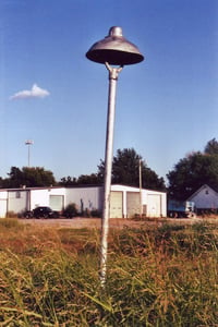 A tall light fixture still stands along the exit road