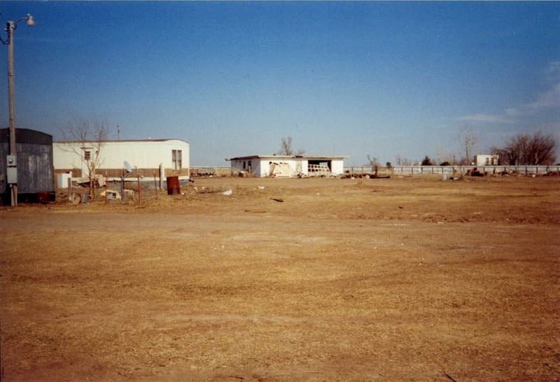 Taken from the northwest corner of the lot. Notice the mobile homes sitting on the north side of the property. Individual property fences have been put up and some of the residences park their cars a ways south of the homes. The original wood fence for