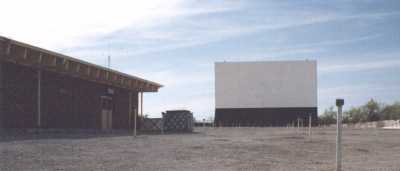 screen, projection booth/concession stand, speaker poles, + perimeter fence