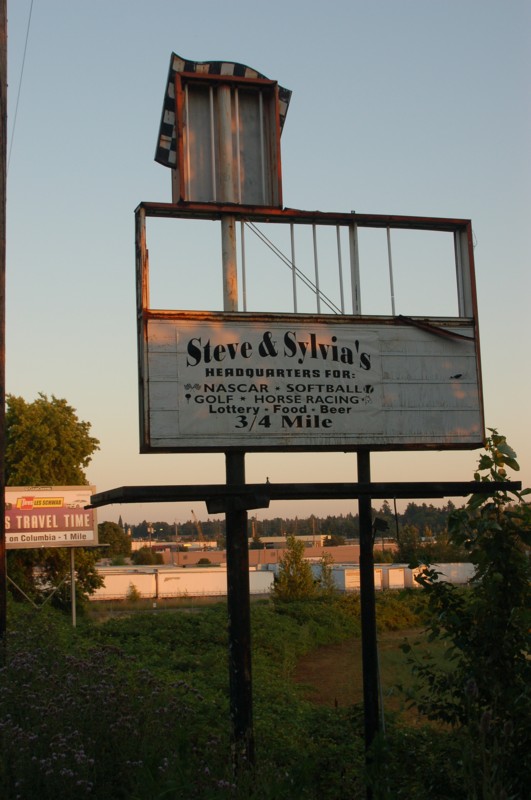 The original marquee on old Hwy 99 Union Blvd. The trucks in the background are where the original entrance exits were pavement is still there. The unused motor-cross track below the sign roughly circles the old parking area and the auto berms can stil