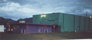 Snack bar, booth, indoor theater.There is a dumpster and power box in front of the snack bar.