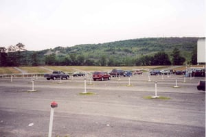 Left side of parking field.