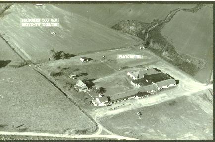 Vintage postcard with area marked proposed drive-in theater behind what looks like a motel.