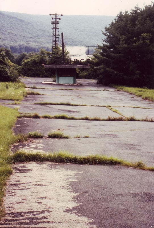 Ticket booth with large letters on top of
roof saying "ENTRANCE" and screen in background