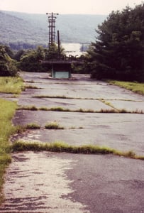 Ticket booth with large letters on top of
roof saying "ENTRANCE" and screen in background