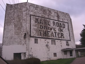 Screen tower of Kane Road Drive-In. Note the windows of the residence, and entry door at lower right.