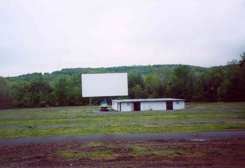 Field, screen, and projection/concession building taken from last parking row.