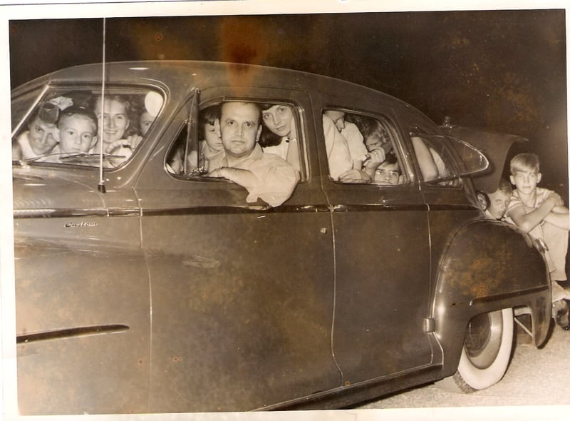 This picture taken at the Nu-Way Drive In entrance in the early 1950's. It was the first night that "$1 a carload" was offered. The car is a 1948 Chrysler. The driver is Walter C.Good of Island Park, Northumberland. There are 35 people in the car. Th