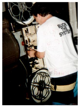 Threading up a reel of Terminator 2 August 16, 1991. One of two projectors from 1950 with use of Carbon Arc lamphouses. Still in use today!