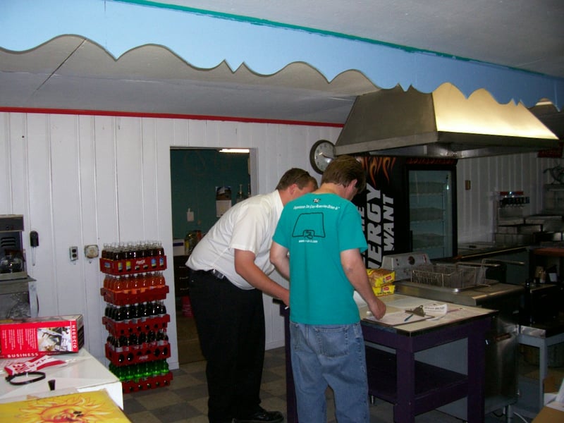 My partner, Joe McDade, signing papers with the Coca-Cola distributors. Notice his Drive-ins.com t-shirt?