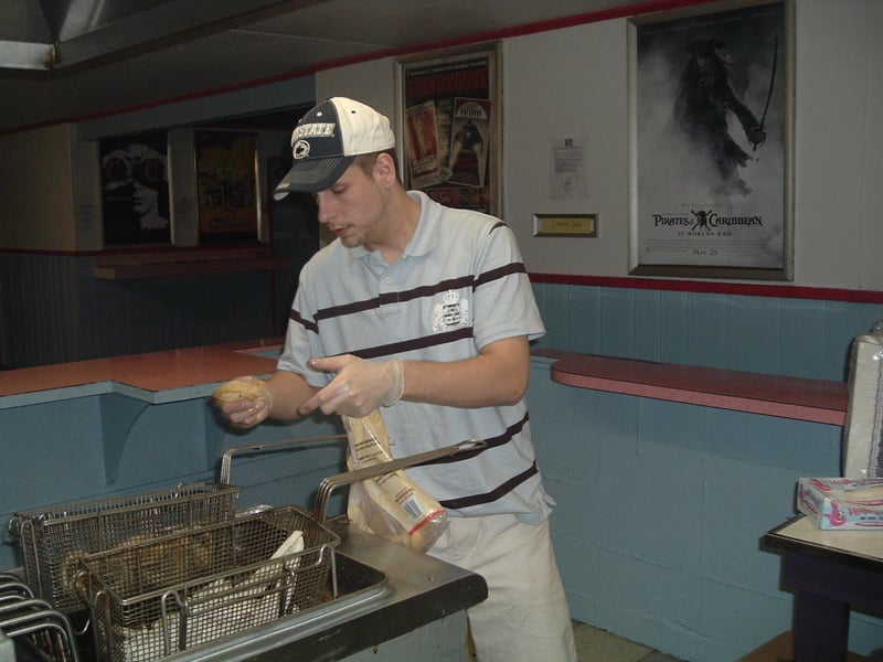 Another busy night in the concession stand. Chris attends to a customers' order.