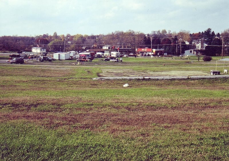 Looking in the direction of screen with
concrete slab of projection/concession building on the grassy field