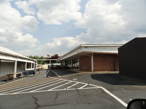 Concession standprojection building along with flea market buildings-ramps are still very evident and asphalt covered