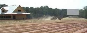 Tullahoma News pic of one of its screens, projection booth/concession stand, and a tractor flattening the lot