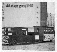 A kiddie train in front of the Alamo's screen tower.