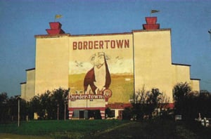 Screen tower with mural of a bull from the book Ticket to Paradise by John Margolies & Emily Gwathmey.