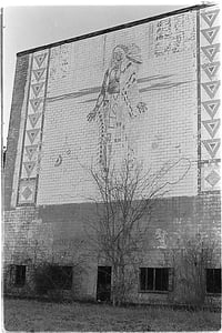 Exterior facing road. Approx 30 years after closing. Landmark structure and its weathered mural has since been demolished.