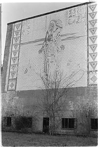 Exterior facing road. Approx 30 years after closing. Landmark structure and its weathered mural has since been demolished.