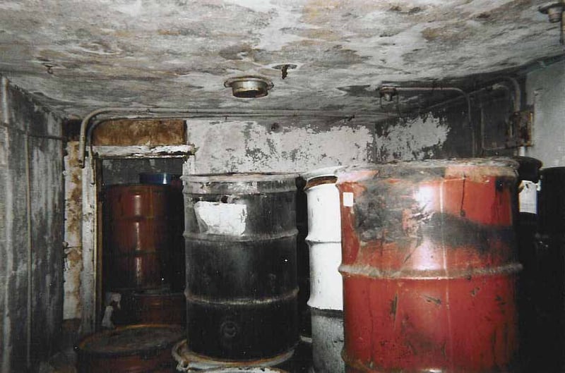 This is the room next to the projection booth. The projection booth is through the door in the background. The projection portholes are closed up with brick. The vent on the ceiling might have been for one of the carbon arc lamphouses.