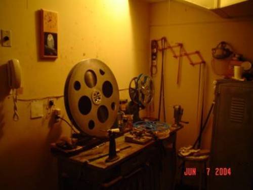 This is the projection booth rewind. One of the 3 big reels of "Troy" is ready to be broken down onto the 20-minute shipping reels.