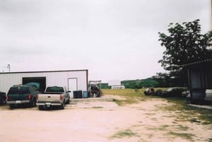 This photo shows the auto repair place in the foreground with the screen and lot behind it. This gives you an idea what you can see from the road.