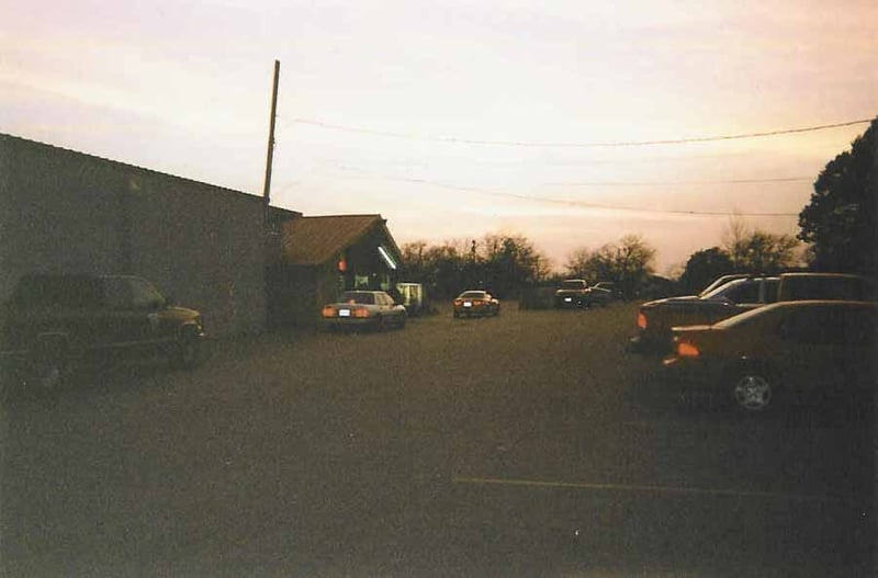 cars driving up to ticket booth at sunset